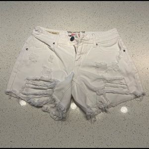 White jean shorts distressed and frayed edge details.